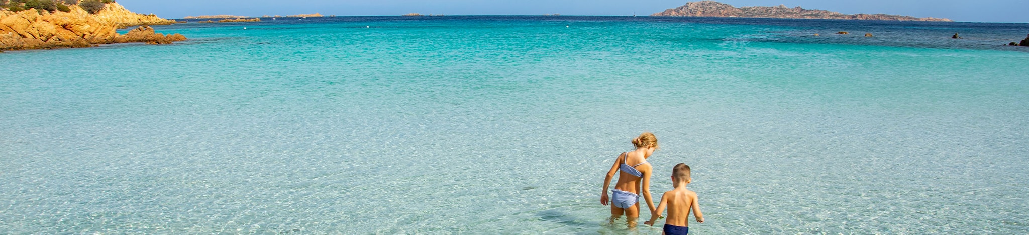 Kinder im azurblauen Wasser auf Sardinien